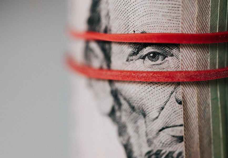 roll of american dollar banknotes tightened with band